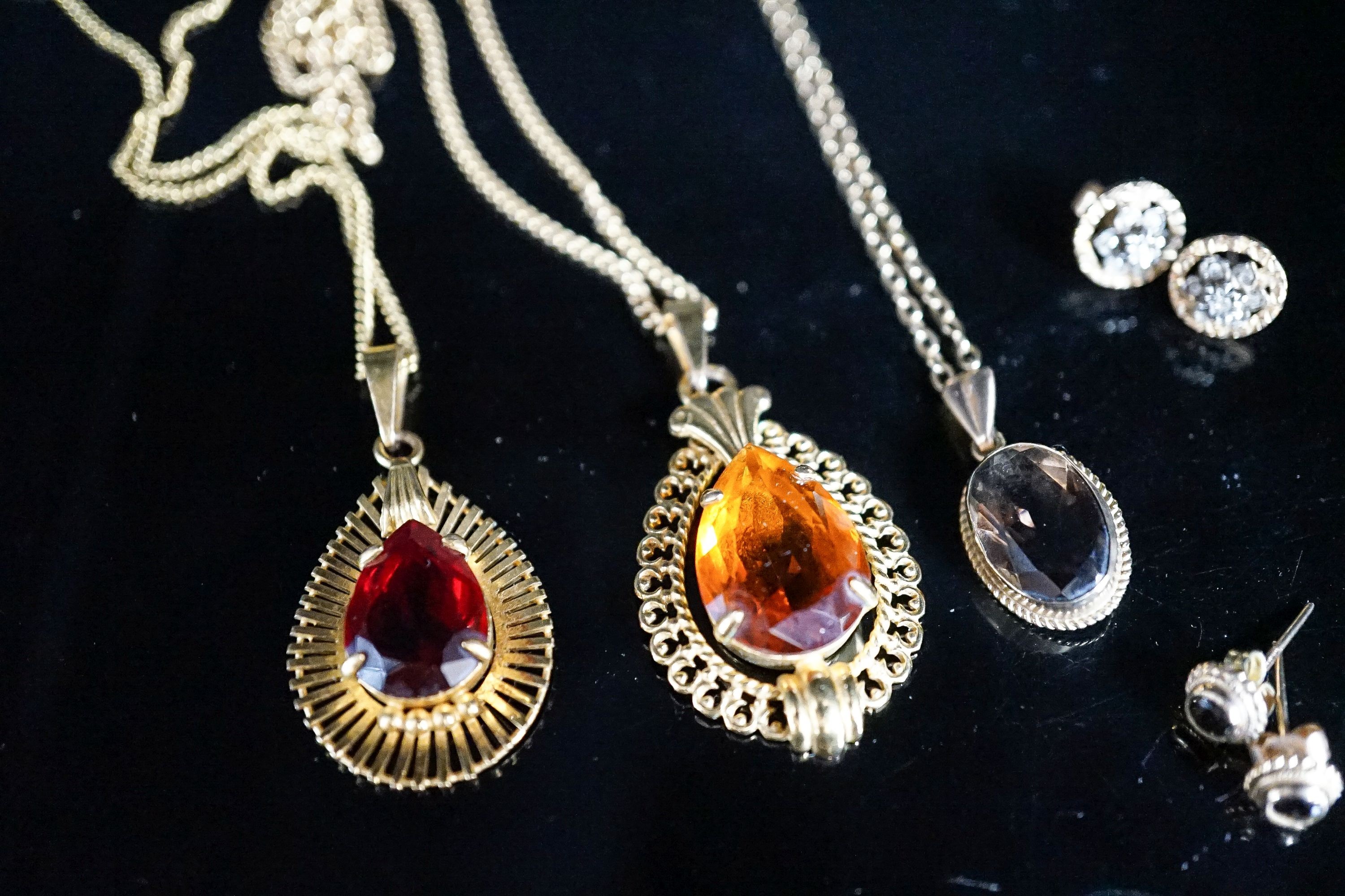 A modern 9ct gold and smoky quartz set pendant on a 9ct chain and two pairs of 9ct earrings, gross 6.2 grams and two other pendants on chains.